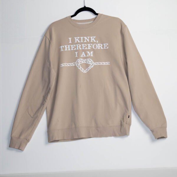 Cream or light tan sweatshirt with white writing.