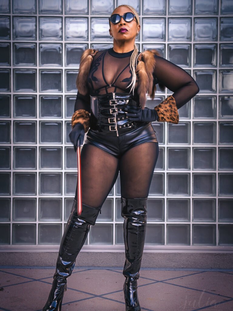 Goddess Aroya standing with a crop held down from her hip