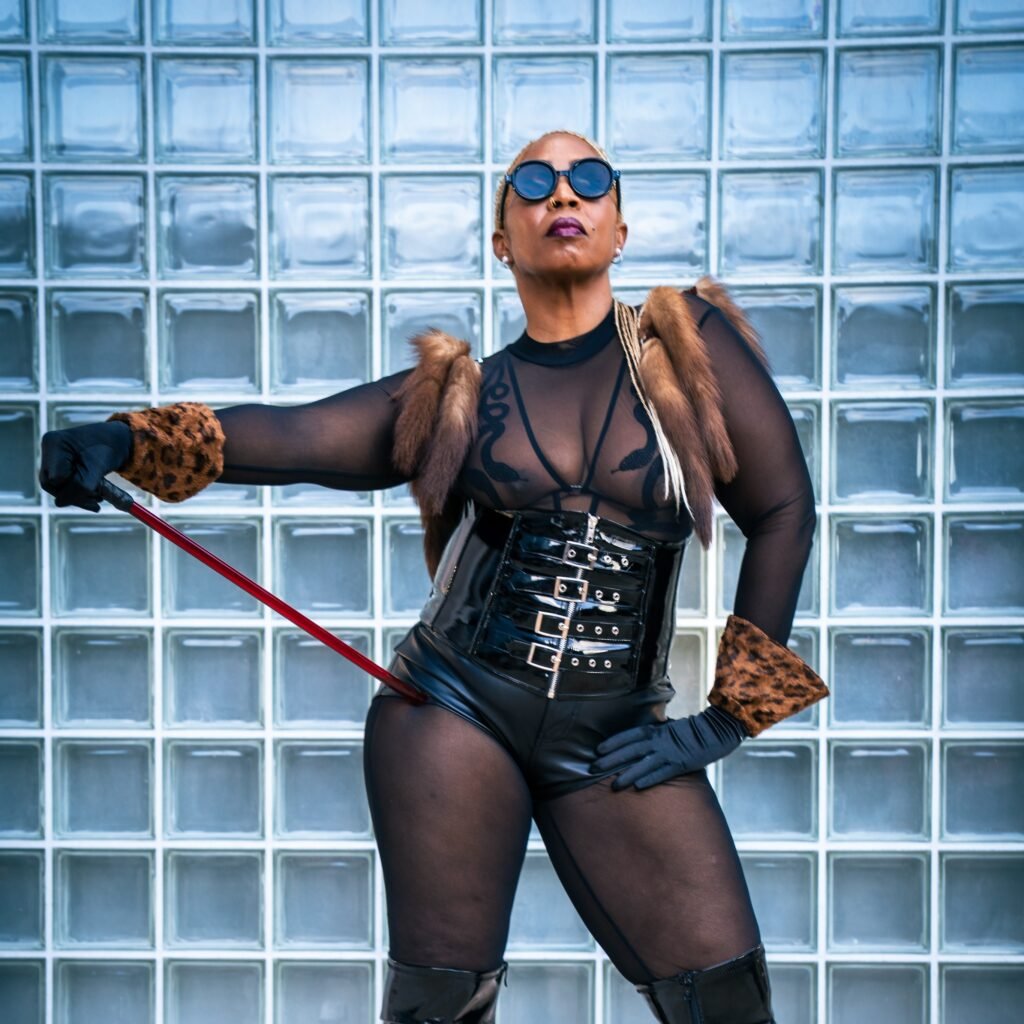 Goddess Aroya standing with a crop held out from her hip